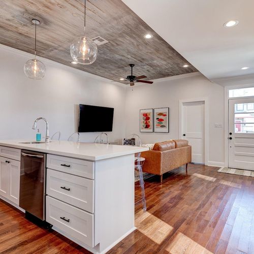 Open-concept kitchen & living area filled w/ natural light & modern finishes.