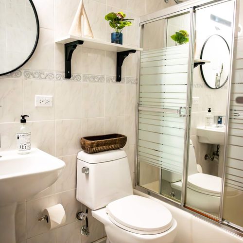 A bright and functional vanity space awaits, offering clear reflections and easy access to essentials. This thoughtful setup ensures a comfortable and hassle-free preparation for your day.