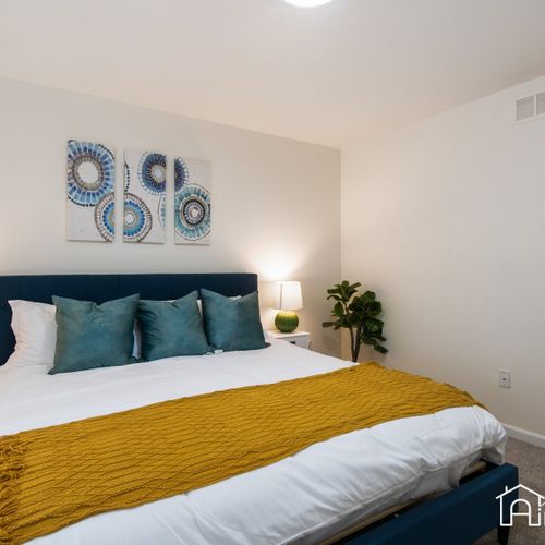 The master bedroom features a king size bed with plush linens, night stands, plenty of space for your luggage, and an attached bathroom. The ensuite bathroom consists of a tub/shower combo, toilet, and tub. Toiletries are provided for your convenience.