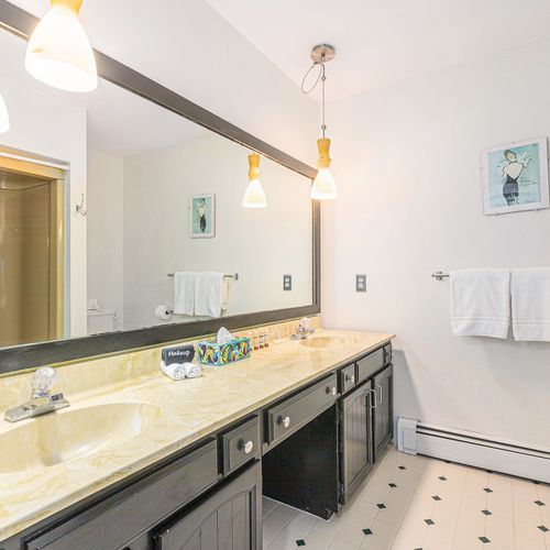 BATHROOM #1:  Full bathroom with dual sinks, combination tub and shower, and a toilet.  Conveniently located near the 4 bedrooms.