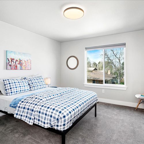 - cheerful bedroom with matching plaid bedding and playful art for a relaxed stay