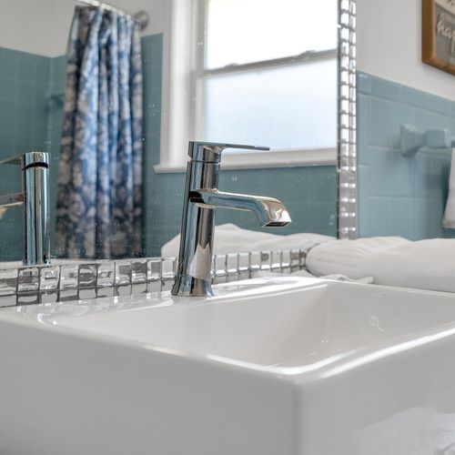 Modern elegance meets classic charm—this sparkling clean sink and stylish fixtures add a fresh touch to your relaxing stay.