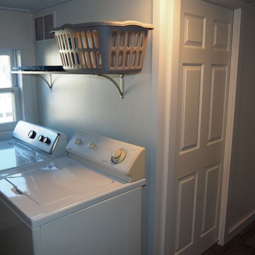 Laundry room:  main floor laundry room with washer, dryer, and sink.