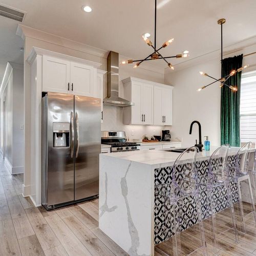 Chef's kitchen w/ sleek counters, stainless appliances & plenty of prep space.