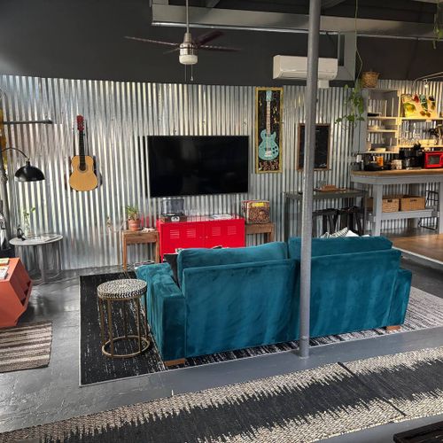 Cozy living area w/ a bold teal sofa — settle in & make yourself at home.