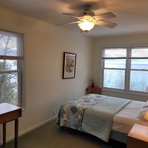 Bedroom #4 (upper level):  very large bedroom featuring a queen-size bed, credenza, ceiling fan, closet, chair, and great views of lake michigan!