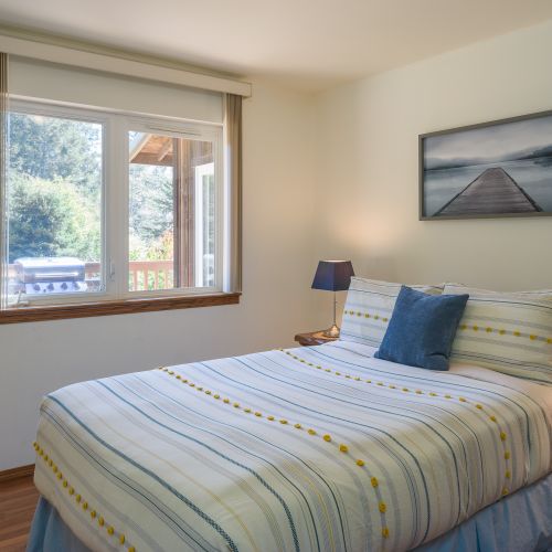 Guest bedroom with a full bed and garden view.