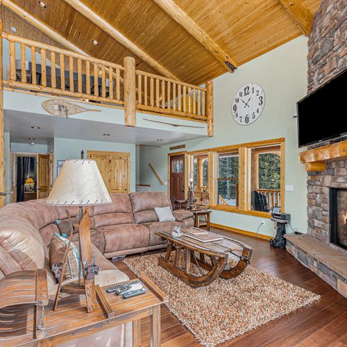 Unwind by the fireplace—ample seating and a tv make this corner extra inviting.