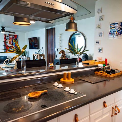 Whip up delicious meals in your fully equipped kitchen, featuring a cooktop, ample counter space, and an open design that connects to the vibrant living area.