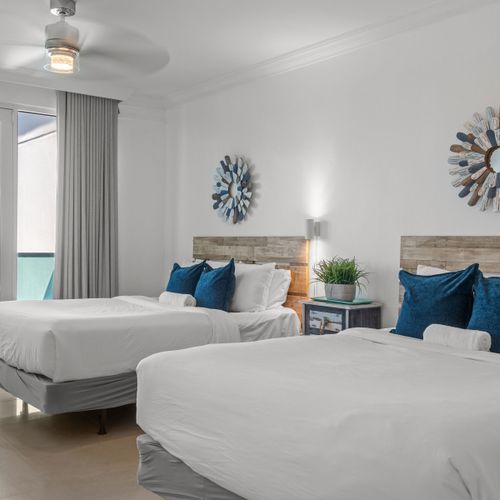 Unwind in comfort with the soothing sounds of the waves. This serene bedroom provides two cozy beds and an unparalleled oceanfront experience, perfect for couples or families.
