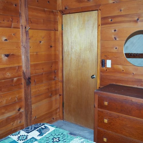 Bedroom #1:  features a full-size bed, chair, dresser, closet, and mirror.