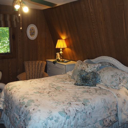 Bedroom:  includes a queen-size bed, dressers, night lamps, ceiling fan, closet, and room a/c unit.
