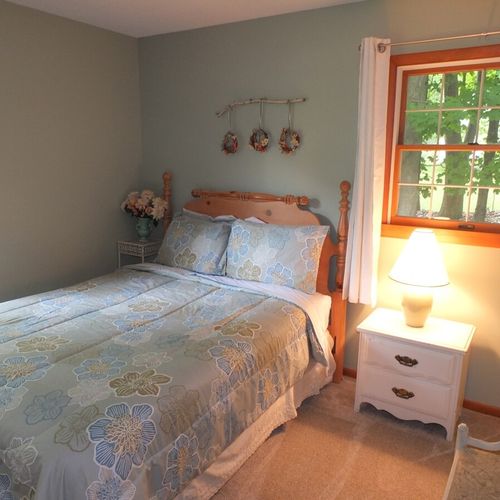 Bedroom #2: features a full-size bed, chair, nightstand, lamp, dresser, and closet.