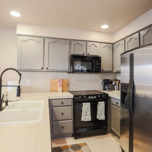 This home features a well-appointed kitchen with stainless steel appliances. Cook your favorite meals with all the utensils and bakeware you need.
