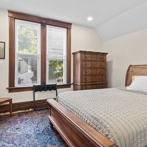 BEDROOM #5 (SECOND FLOOR):  Features a queen-size bed, dresser, 2 chairs, 2 lamps, and a closet.