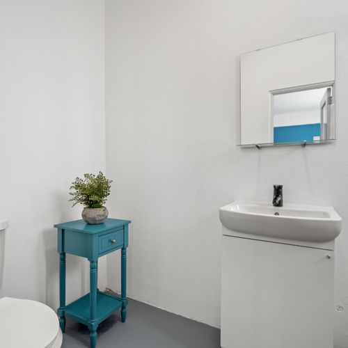 A bathroom oasis awaits, boasting sleek surfaces and neutral tones.