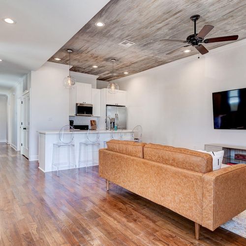 Open living room w/ soaring ceilings & plush seating for easy gathering.