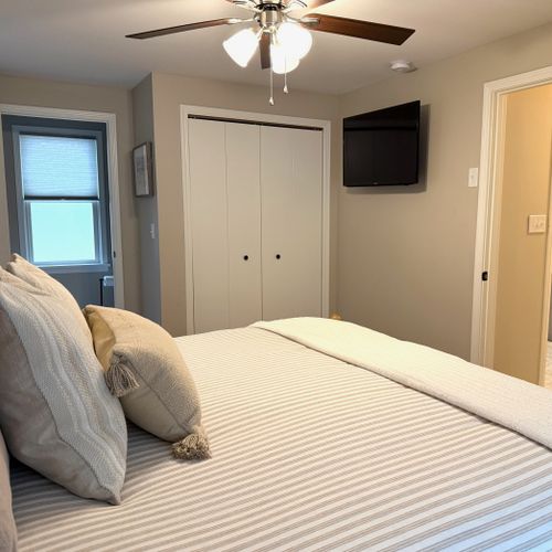Bedroom #1:  features a king-size bed, ceiling fan, private television and private en suite full bathroom!