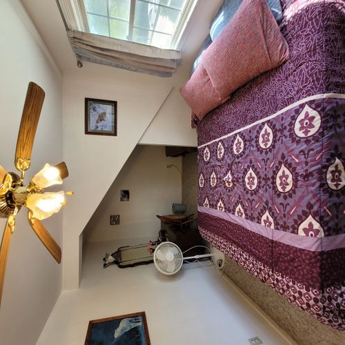 Bedroom #1 ( second floor):  large master bedroom with a queen-size bed, closet, vanity, ceiling fan, pedestal fan, and nightstand.