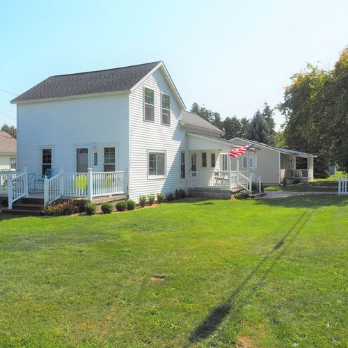 Exterior:  a side angle of the house in summer.