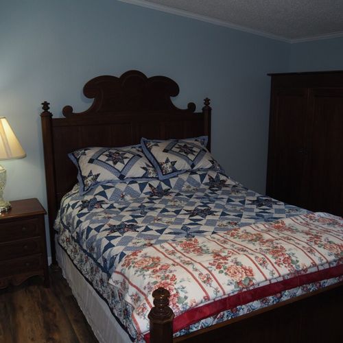 Bedroom #1 (master bedroom):  another angle showing the queen-size bed, nightstand, lamp, and one of the dressers.