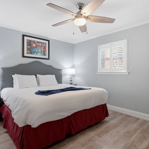 Cozy bed dressed in crisp linens — ready for a restful night's sleep.