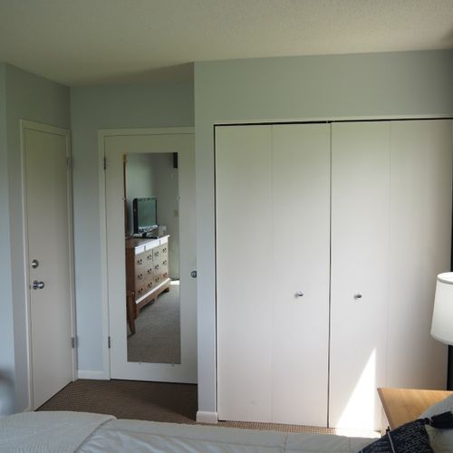 Guest bedroom:  features a queen-size bed, private entrance from the deck, nightstands with lamps, a dresser, closet, chair, and its own television.
