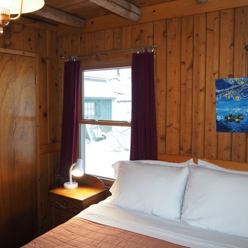 Bedroom #1 (main floor):  features a queen-size bed, nightstands with lamps, a dresser and a closet.