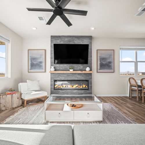 Relax in this open living space with a cozy fireplace and fully equipped modern kitchen.