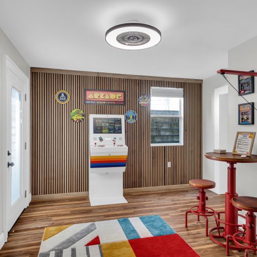 Vibrant game room w/ arcade games & bold décor — the ultimate hangout spot.