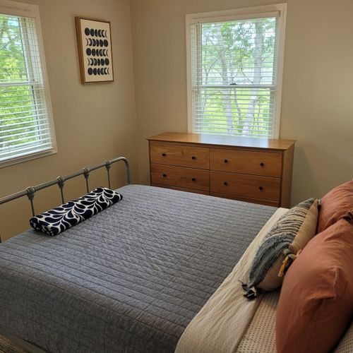 Bedroom #1:  bedroom #1 features a queen-size bed, ceiling fan, dresser, and a closet.
