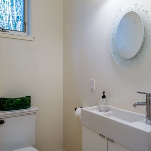 A clean and bright half bath with modern fixtures and a fresh, minimalist design.