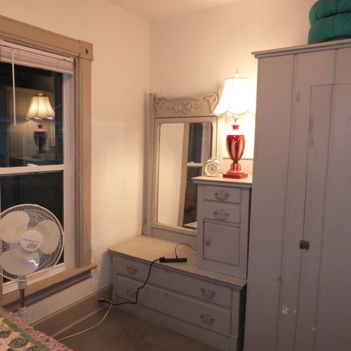 Bedroom #1 (main floor):  features a queen-size bed, mirror, dresser, and closet.