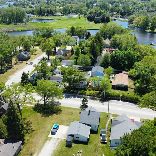 Exterior:  an aerial photo  looking south from the house with the au sable river in the background.