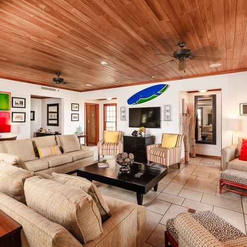 Relax in the stylish and large living area of the penthouse, featuring contemporary décor, comfortable seating, and plenty of natural light—perfect for unwinding after a day at Langosta Beach.