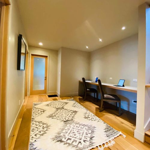 Laundry room and two lower guest bedrooms off of the walkway/remote work area.