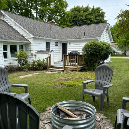 Exterior:  the backyard, backyard deck, and the fire pit in the backyard
