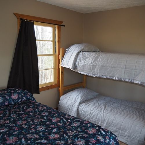 Main room:  another angle of the main room, highlighting the full-size bed and the bunk bed.
