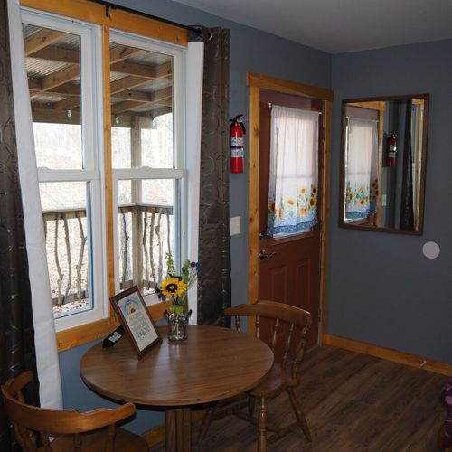 Main room:  the main room, which features 6 beds (5 twins and 1 double), a small dining table, and a small sink / kitchenette.