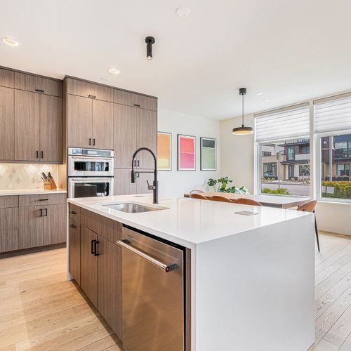 A modern white kitchen island adds plenty of space to create your favorite dishes.