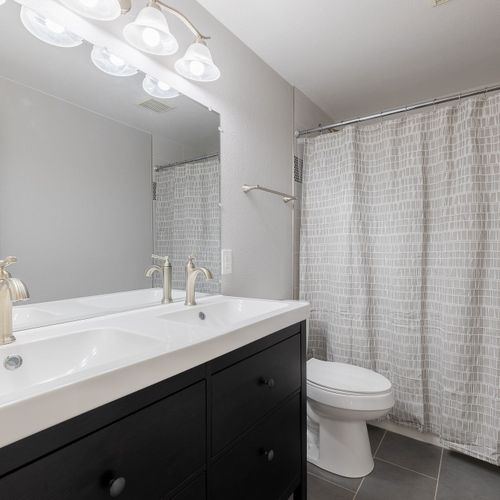 Each floor offers a full bathroom, complete with newly tiled walk-in showers and modern amenities, ensuring optimal comfort.