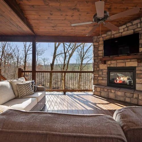The outdoor covered patio with oversized outdoor sectional around the fireplace