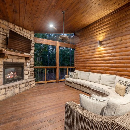 The outdoor covered patio with oversized outdoor sectional around the fireplace
