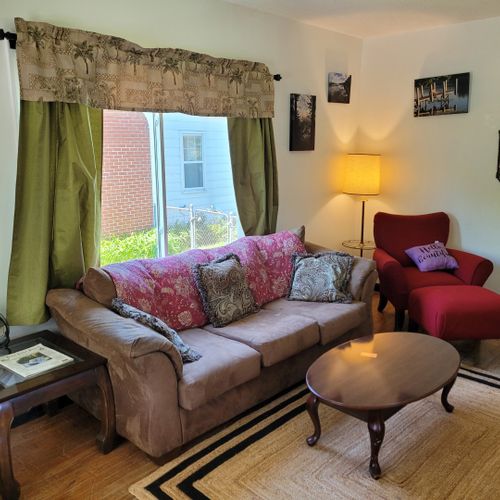 Living room:  the home has a very cozy living room with 2 sofas, a comfy chair, and a television.