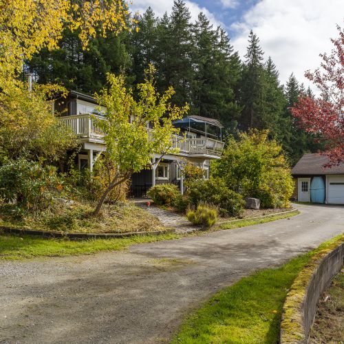 A quiet, tree-lined drive leads you home—ample parking, easy access, and a warm welcome framed by seasonal colors and forest views. Arrival here feels calm and unhurried from the moment you pull in.