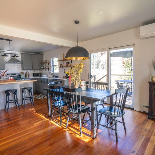 The open concept flows between the living room, dining area, and kitchen.