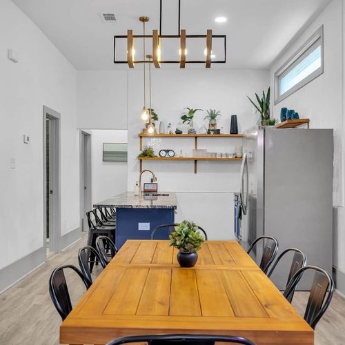 Bright dining nook w/ a wood table & natural light — a great spot for morning coffee.