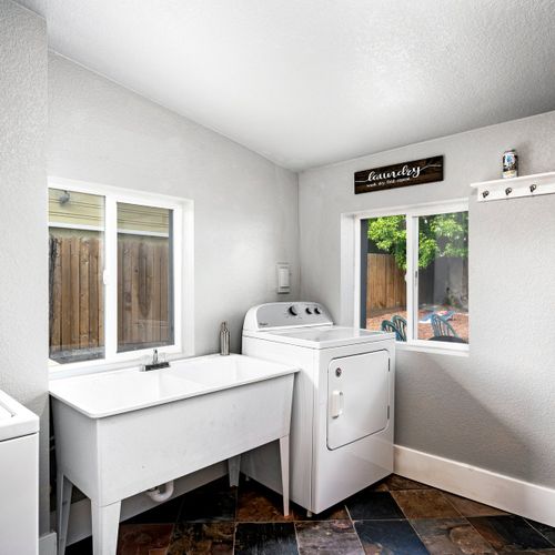 The laundry room has all the essentials you need! It contains a washer/dryer, utility sink, ironing board, and iron. Detergent is available for your convenience.