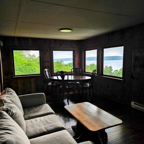 Living room:  the living room with the couch and table with a view of crystal lake