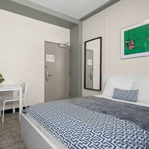 Experience ultimate comfort in our well-lit bedroom, complete with modern furnishings, blackout blinds for undisturbed sleep, and a refreshing air conditioning unit to keep you cool.